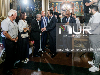 President of Cyprus Nikos Christodoulides is greeting a civilian in Kykkos, Cyprus, on August 4, 2024. President of Cyprus Nikos Christodoul...