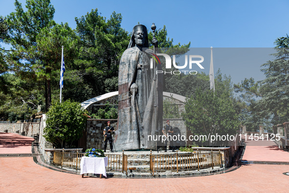 Two soldiers are standing in front of the Makarios statue in Kykkos, Cyprus, on August 4, 2024. The President of Cyprus, Nikos Christodoulid...