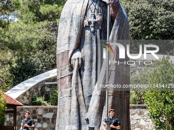 Two soldiers are standing in front of the Makarios statue in Kykkos, Cyprus, on August 4, 2024. The President of Cyprus, Nikos Christodoulid...