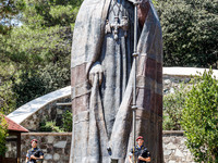 Two soldiers are standing in front of the Makarios statue in Kykkos, Cyprus, on August 4, 2024. The President of Cyprus, Nikos Christodoulid...