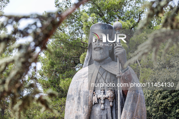 A Makarios statue is being seen through a tree in Kykkos, Cyprus, on August 4, 2024. The President of Cyprus, Nikos Christodoulides, is atte...