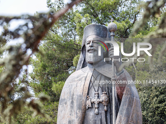 A Makarios statue is being seen through a tree in Kykkos, Cyprus, on August 4, 2024. The President of Cyprus, Nikos Christodoulides, is atte...