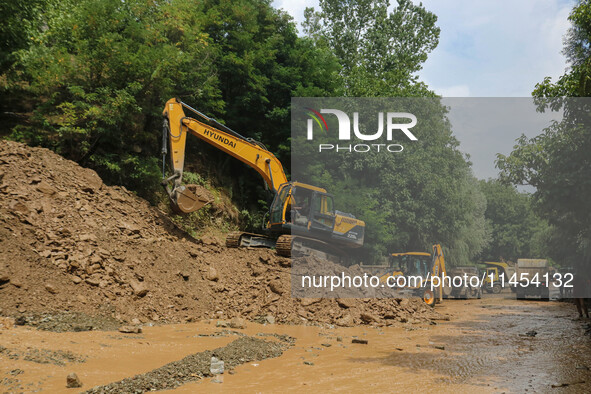 Excavators are removing debris after a cloudburst near Cherwan Padabal area in central Kashmir's Ganderbal district, some 42 kilometers from...