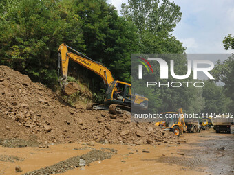 Excavators are removing debris after a cloudburst near Cherwan Padabal area in central Kashmir's Ganderbal district, some 42 kilometers from...