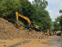 Excavators are removing debris after a cloudburst near Cherwan Padabal area in central Kashmir's Ganderbal district, some 42 kilometers from...