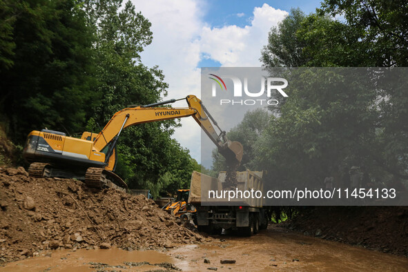 An excavator is removing debris after a cloudburst near Cherwan Padabal area in central Kashmir's Ganderbal district, some 42 kilometers fro...