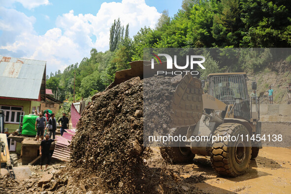 An excavator is removing debris after a cloudburst near Cherwan Padabal area in central Kashmir's Ganderbal district, some 42 kilometers fro...