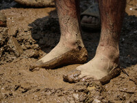 A man is standing in the mud after a cloudburst near Cherwan Padabal area in central Kashmir's Ganderbal district, some 42 kilometers from S...