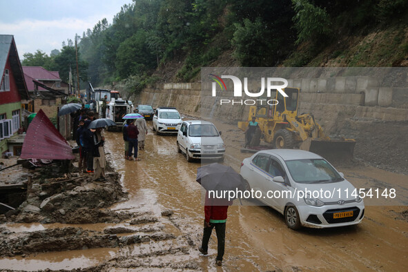 Vehicles are moving along the Srinagar-Leh Highway after a cloudburst near Cherwan Padabal area in central Kashmir's Ganderbal district, som...