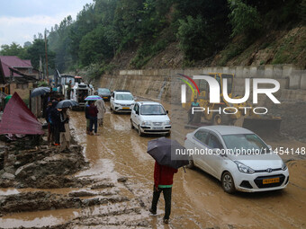 Vehicles are moving along the Srinagar-Leh Highway after a cloudburst near Cherwan Padabal area in central Kashmir's Ganderbal district, som...