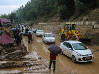 Vehicles are moving along the Srinagar-Leh Highway after a cloudburst near Cherwan Padabal area in central Kashmir's Ganderbal district, som...