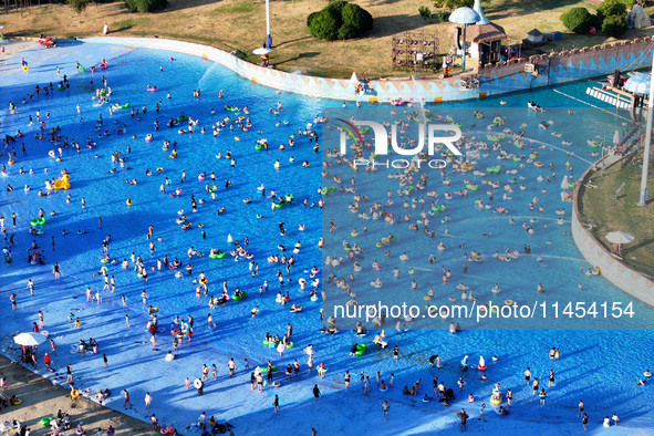 People are enjoying the cool water at a water park in Nanjing, China, on August 4, 2024. 