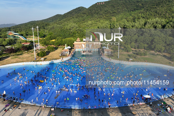 People are enjoying the cool water at a water park in Nanjing, China, on August 4, 2024. 