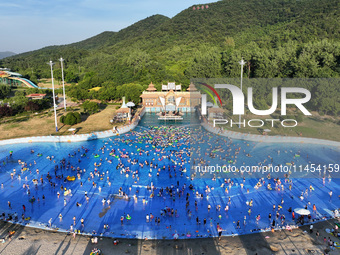 People are enjoying the cool water at a water park in Nanjing, China, on August 4, 2024. (