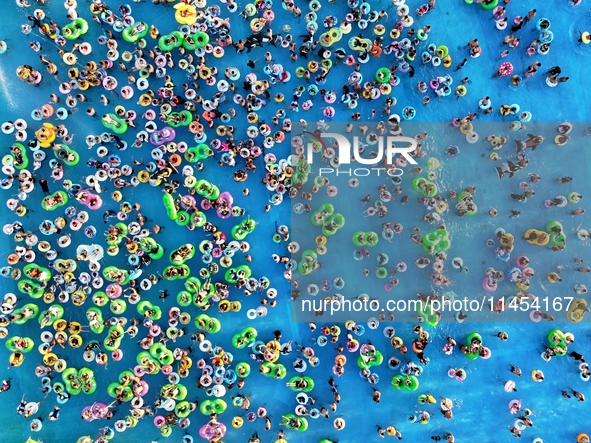 People are enjoying the cool water at a water park in Nanjing, China, on August 4, 2024. 