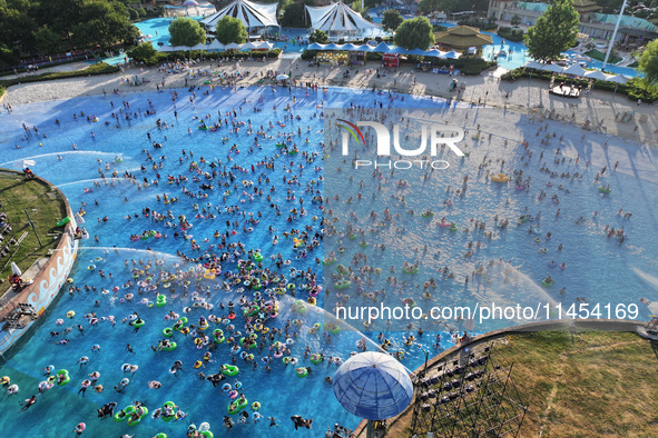 People are enjoying the cool water at a water park in Nanjing, China, on August 4, 2024. 