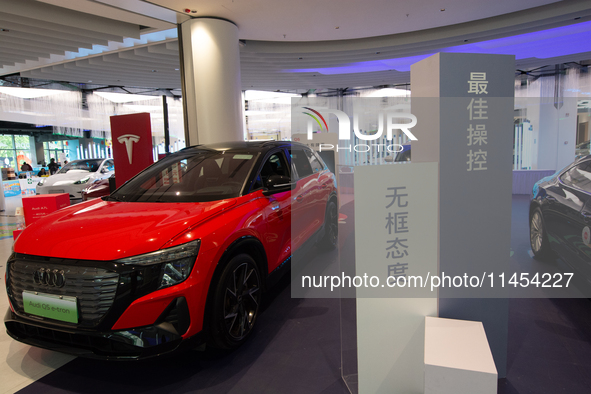 A general view is showing 70 models from Tesla, Audi, Hongqi, SAIC Volkswagen, and Jiyue Nio on display during the Auto Shopping Festival at...