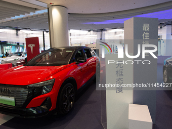 A general view is showing 70 models from Tesla, Audi, Hongqi, SAIC Volkswagen, and Jiyue Nio on display during the Auto Shopping Festival at...