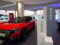 A general view is showing 70 models from Tesla, Audi, Hongqi, SAIC Volkswagen, and Jiyue Nio on display during the Auto Shopping Festival at...