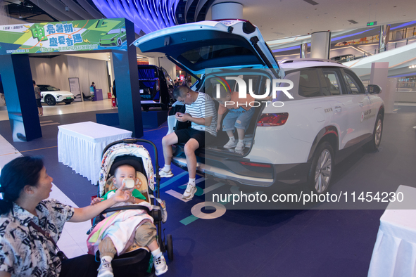 A general view is showing 70 models from Tesla, Audi, Hongqi, SAIC Volkswagen, and Jiyue Nio on display during the Auto Shopping Festival at...