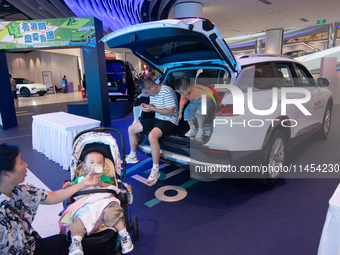 A general view is showing 70 models from Tesla, Audi, Hongqi, SAIC Volkswagen, and Jiyue Nio on display during the Auto Shopping Festival at...