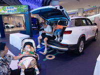 A general view is showing 70 models from Tesla, Audi, Hongqi, SAIC Volkswagen, and Jiyue Nio on display during the Auto Shopping Festival at...