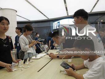 People are experiencing Huawei mobile phones at the Huawei store in Wangfujing, Beijing, China, on August 4, 2024. (