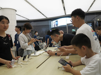 People are experiencing Huawei mobile phones at the Huawei store in Wangfujing, Beijing, China, on August 4, 2024. (