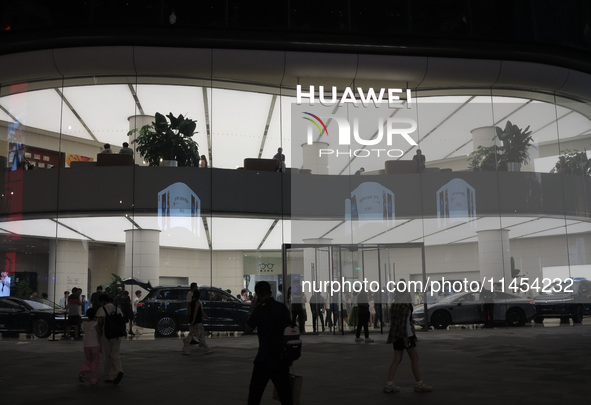 People are experiencing Huawei mobile phones at the Huawei store in Wangfujing, Beijing, China, on August 4, 2024. 