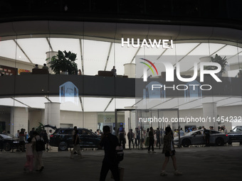 People are experiencing Huawei mobile phones at the Huawei store in Wangfujing, Beijing, China, on August 4, 2024. (