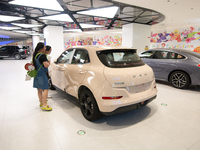 People are checking on a SAIC Volkswagen auto as 70 models of auto dealers from Tesla, Audi, Hongqi, SAIC Volkswagen, and Jiyue Nio are on d...