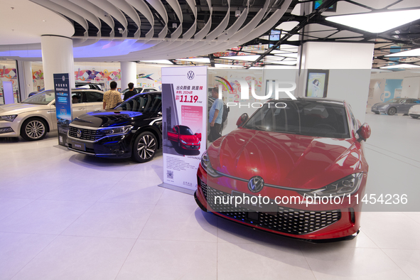 A general view is showing 70 models from Tesla, Audi, Hongqi, SAIC Volkswagen, and Jiyue Nio on display during the Auto Shopping Festival at...