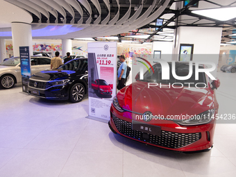 A general view is showing 70 models from Tesla, Audi, Hongqi, SAIC Volkswagen, and Jiyue Nio on display during the Auto Shopping Festival at...