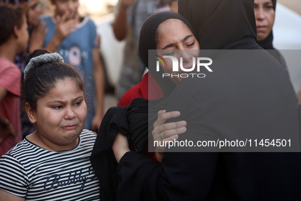 Palestinians are mourning a member of their family in the aftermath of a reported overnight Israeli strike that hit tents used as temporary...