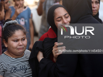 Palestinians are mourning a member of their family in the aftermath of a reported overnight Israeli strike that hit tents used as temporary...