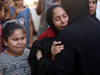 Palestinians are mourning a member of their family in the aftermath of a reported overnight Israeli strike that hit tents used as temporary...