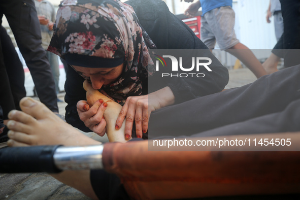 (EDITOR'S NOTE: Graphic content) A Palestinian woman is bidding farewell to a member of her family in the aftermath of a reported overnight...