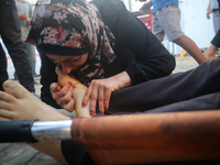 (EDITOR'S NOTE: Graphic content) A Palestinian woman is bidding farewell to a member of her family in the aftermath of a reported overnight...