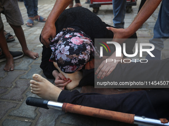 (EDITOR'S NOTE: Graphic content) A Palestinian woman is bidding farewell to a member of her family in the aftermath of a reported overnight...