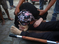 (EDITOR'S NOTE: Graphic content) A Palestinian woman is bidding farewell to a member of her family in the aftermath of a reported overnight...