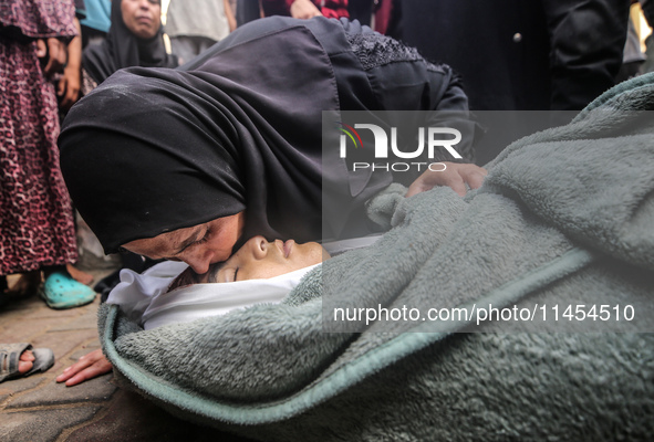 (EDITOR'S NOTE: Graphic content) A Palestinian woman is bidding farewell to a member of her family in the aftermath of a reported overnight...