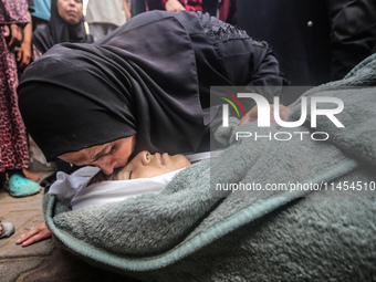 (EDITOR'S NOTE: Graphic content) A Palestinian woman is bidding farewell to a member of her family in the aftermath of a reported overnight...