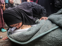 (EDITOR'S NOTE: Graphic content) A Palestinian woman is bidding farewell to a member of her family in the aftermath of a reported overnight...