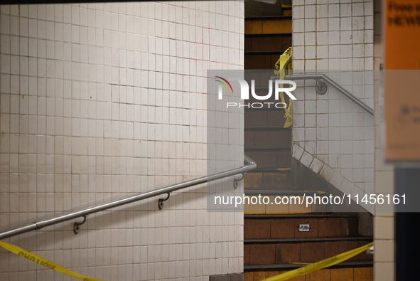 The train platform is being closed off by crime scene tape. Two females are being pushed onto the New York City subway platform by a female...