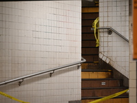 The train platform is being closed off by crime scene tape. Two females are being pushed onto the New York City subway platform by a female...