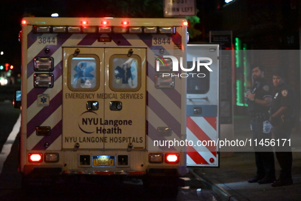 An ambulance is attending to the two female victims at the crime scene. Two females are being pushed onto the New York City subway platform...