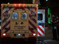 An ambulance is attending to the two female victims at the crime scene. Two females are being pushed onto the New York City subway platform...