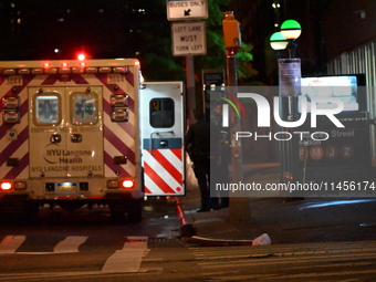 An ambulance is attending to the two female victims at the crime scene. Two females are being pushed onto the New York City subway platform...