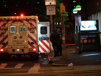 An ambulance is attending to the two female victims at the crime scene. Two females are being pushed onto the New York City subway platform...