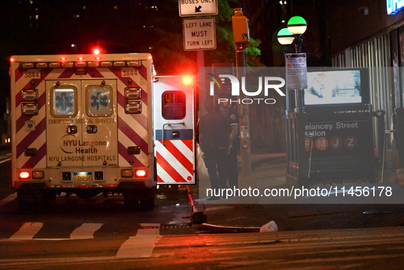 An ambulance is attending to the two female victims at the crime scene. Two females are being pushed onto the New York City subway platform...